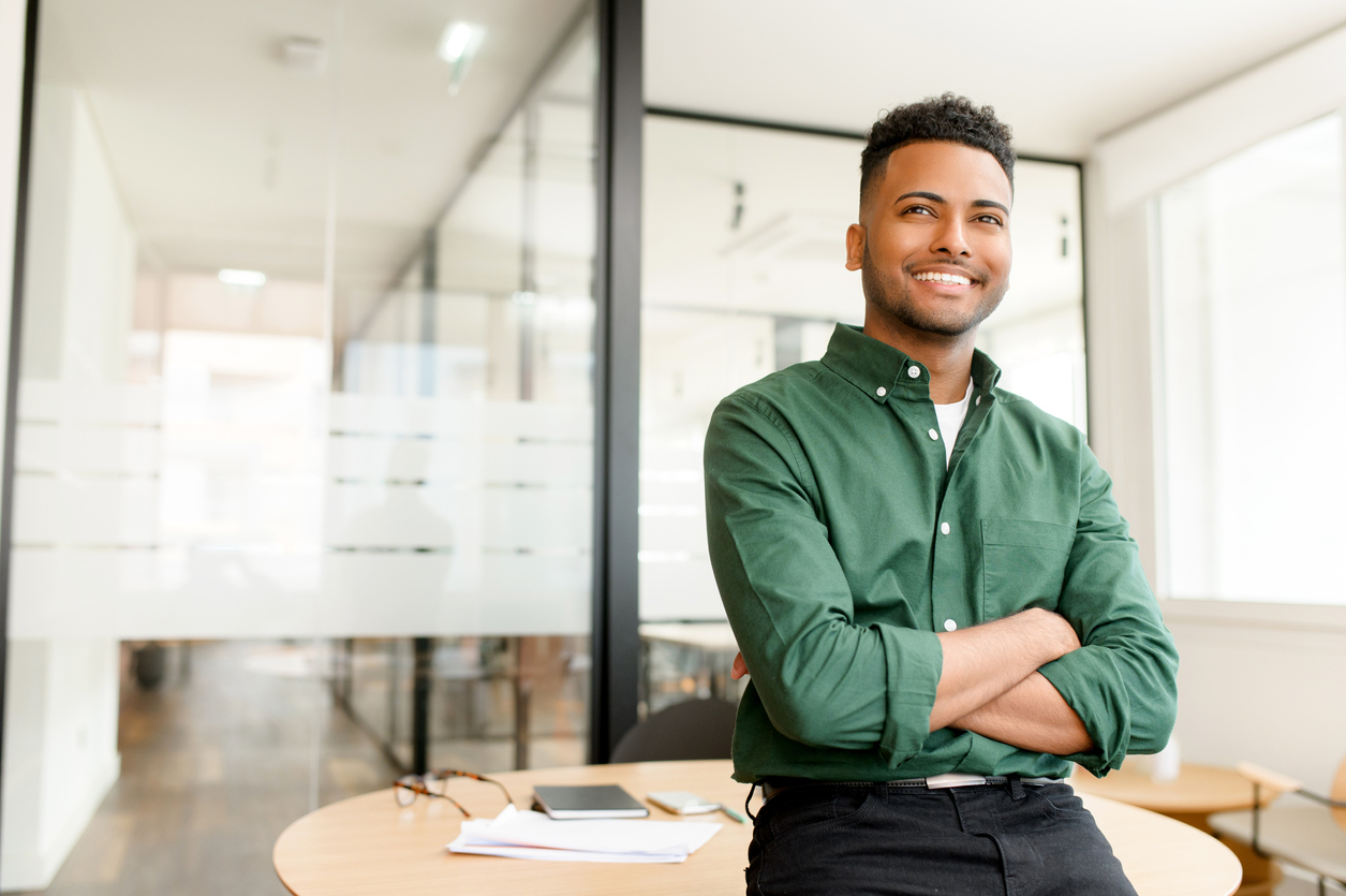 A confident young professional in a modern office